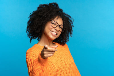 women showing teeth pointing