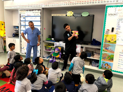 AN image of our beloved kid’s dentists, led by Dr. E, who are teaching kids proper brushing techniques